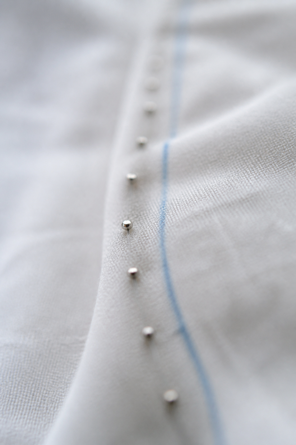 Pinheads on fabric fold representing pinned service decisions